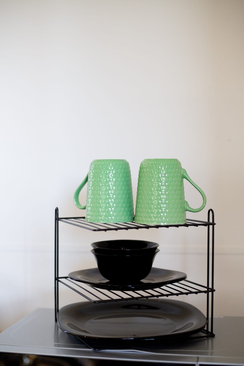 Simple kitchenette details with mugs, bowls, and plates arranged for a convenient self-catering stay.